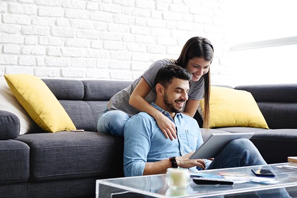 A young couple uses a laptop